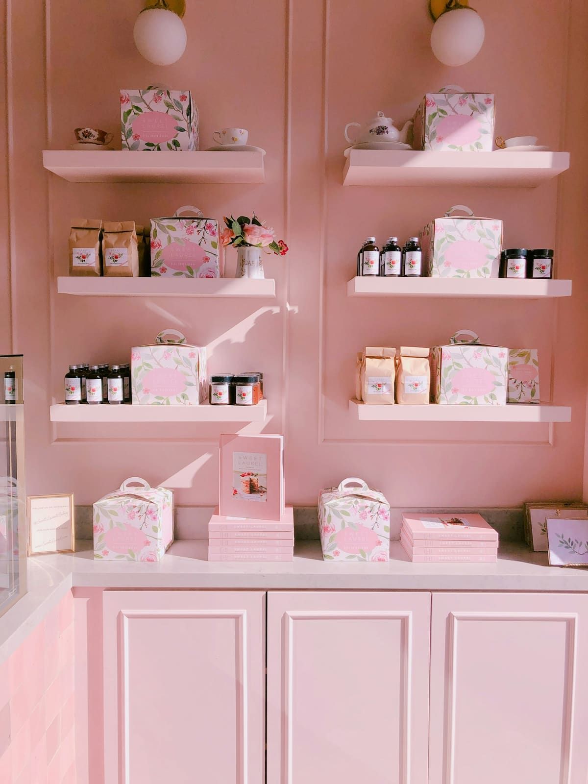 Étagères rose poudré présentant les soins vendus au salon